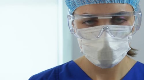 Female Doctor Wearing Mask and Protective Glasses