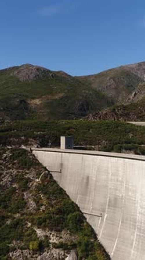 Vertical Video of Hydroelectric power station surrounded with mountains