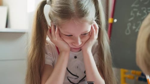 Little Girl Doing Homework At Table