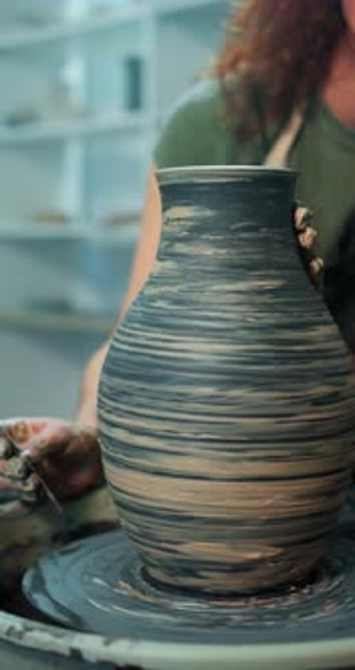 Potter Shaping Clay on Spinning Pottery Wheel