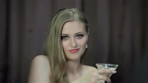 Blonde Woman Holds Martini Glass
