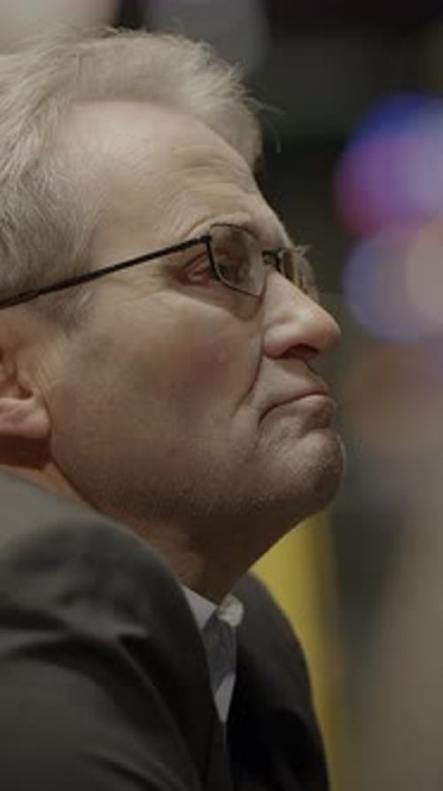 Man in Suit with Face in Hands