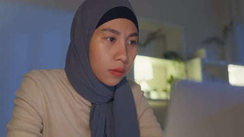 Asia muslim freelancer women face wear hijab casual cloth focus on computer laptop at home office.