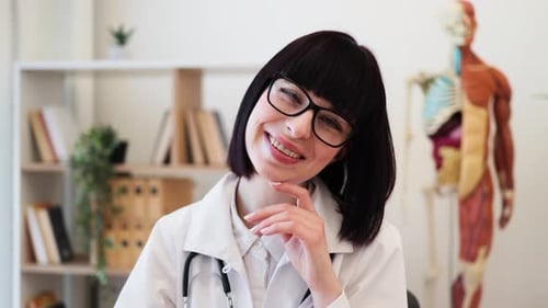 Confident Female Doctor at Office Desk Ready to Assist Patients