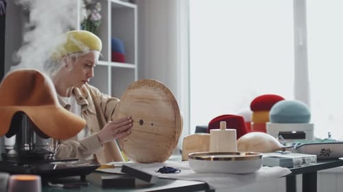 Woman Creating Hats in Studio with Steam
