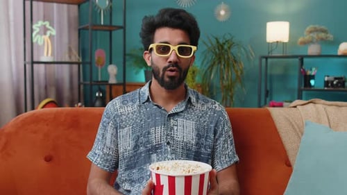 Man Watching a Movie with Popcorn at Home