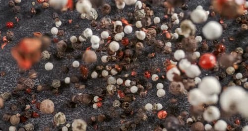 Mixed peppercorns in a super slow motion. Dry mix peppercorns close up.