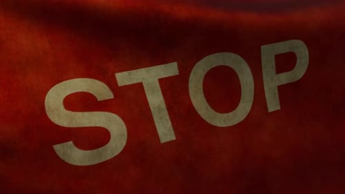 Closeup Animation of the Fluttering Flag with the Word STOP on Worn Fabric