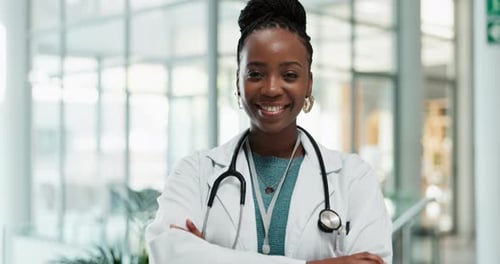 Black woman, doctor and happy face with arms crossed and professional with confidence in hospital