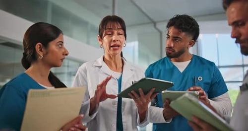 Doctor, tablet and group discussion in hospital for shift handover, task delegation or schedule