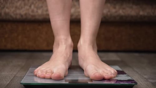 Bare Feet Stepping on Bathroom Digital Scale