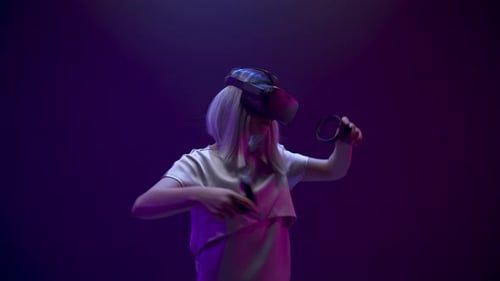 Woman wearing VR headset and holding controllers