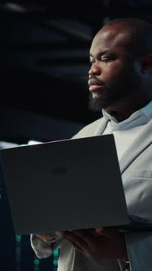 Vertical Video Data Center Admin Coding Writing Script on Laptop Identifying Bottlenecks