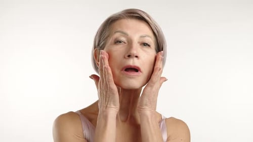 Senior Woman Massaging Face for Beauty
