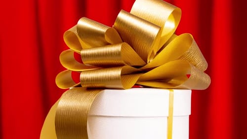 Gift Rotating with Gold Bow and Red Curtain
