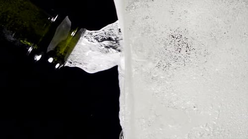 Super Slow Motion of Clean Wine Glass with Champagne Bubbles Texture Filled with Dry White Wine