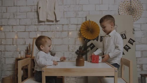Small children play at the table in the room
