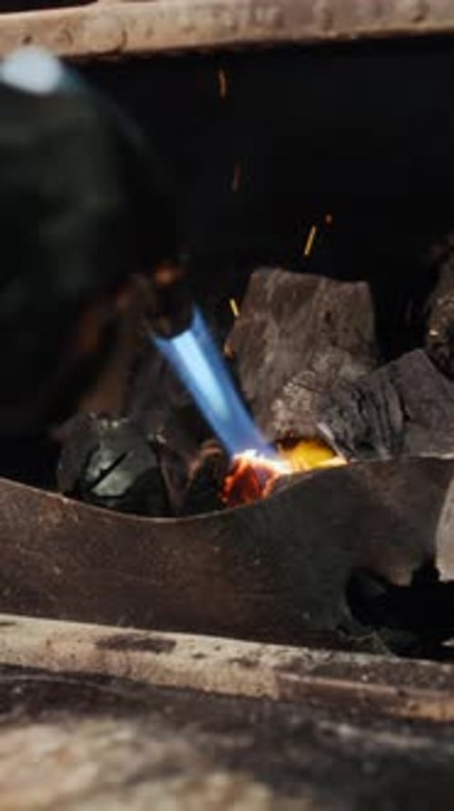 Man using Torch Lighting Restaurant Grill Vertical