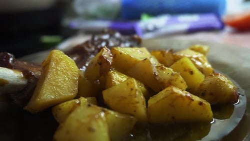 Savory roasted potatoes, close-up, appetizing food preparation