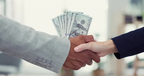 Handshake, bribery and crime with business people in an office exchanging the payment of cash