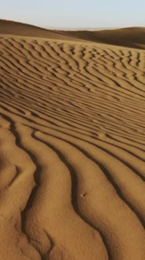 Sand Blowing Over Sand Dunes in Desert