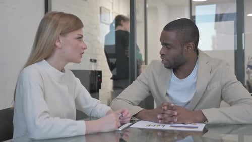 Business Colleagues Discussing Charts in Modern Office