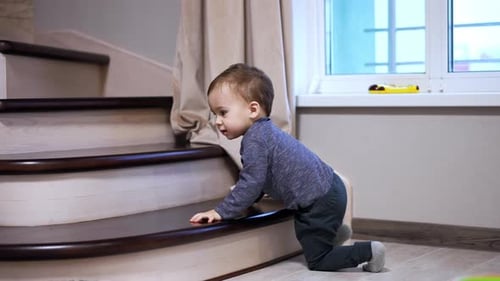 Child Crawling Up Wooden Staircase Indoors