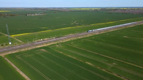 High Speed Train Travels Through Rural Landscape