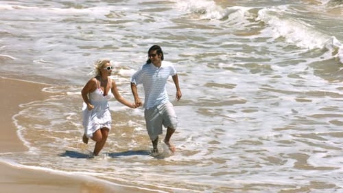 Young Couple Running on Beach,