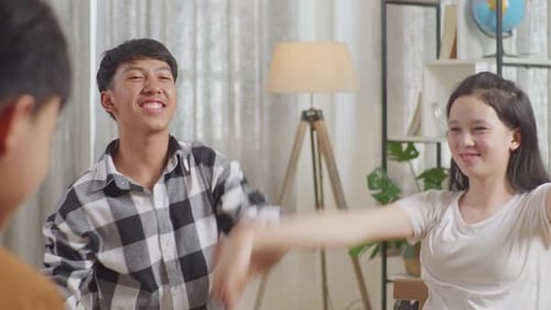 Close Up Of Asian Teen Group Sitting And Discussing At Home. Take Each Others Hands