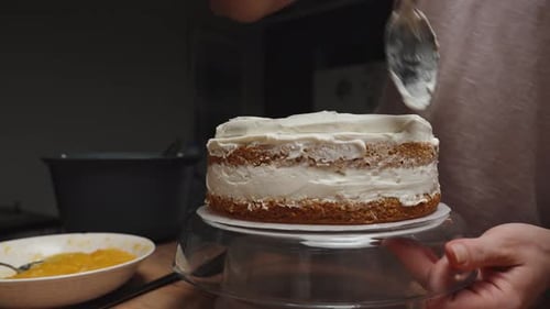 Frosting a Delicious Cake with White Frosting