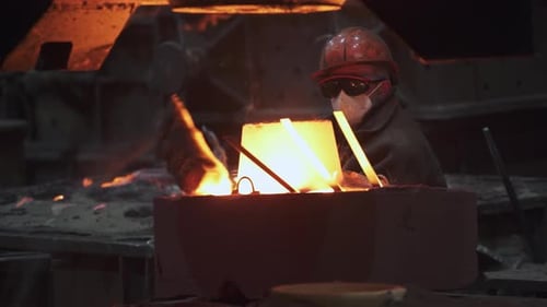 Metal Worker in Foundry at Night