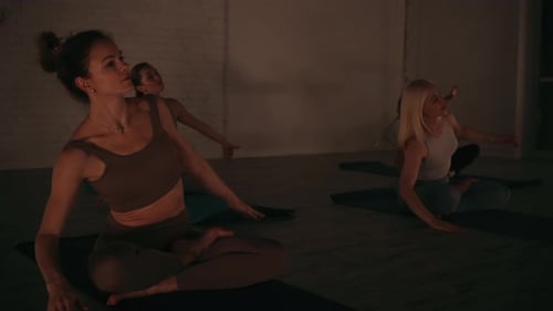 Women Practicing Yoga Poses in Serene Studio