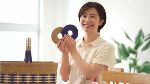 Smiling Woman Crafts Woven Basket at Home
