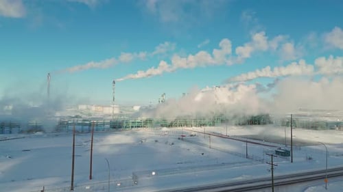 Aerial View of Industrial Complex in Snowy Winter Landscape