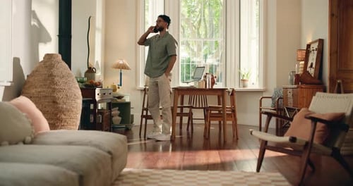Man Talking on Phone in Bright Living Room