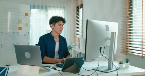 Young Adult Working on Computer at Home Office