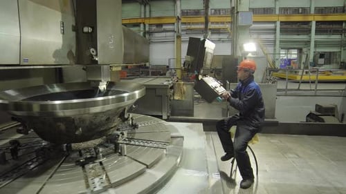 A Worker Skillfully Operating Industrial Machinery in a Bustling Manufacturing Plant Setting Stock