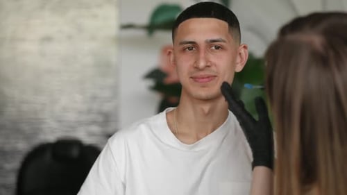 Portrait of Smiling Young Man Talking with Woman Styling Eyebrows with Tweezers Positive Middle