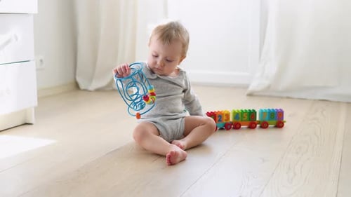 Happy Infant Playing with Toy in Bright Home