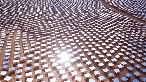 Solar power tower mirrors focus sun rays upon a collector tower