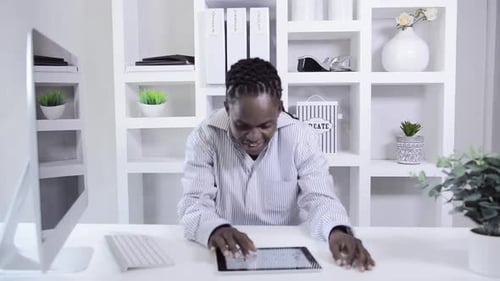 African American Man Working With Tablet Computer In Home Office