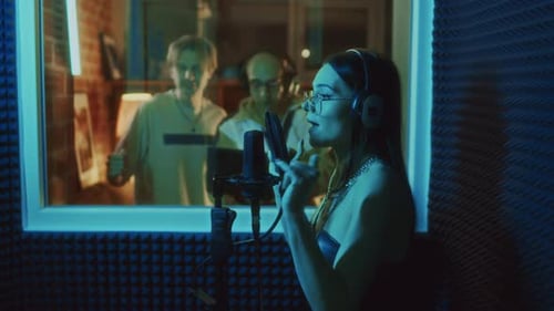 Female Vocalist Signing in Recording Booth During Music Production