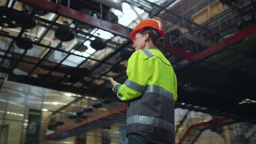 Industrial Supervisor Inspecting Warehouse Tablet