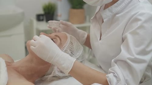Woman Receiving a Facial Treatment in Spa