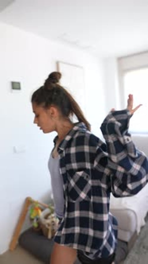 Woman Dancing Expressively in a Modern Living Room