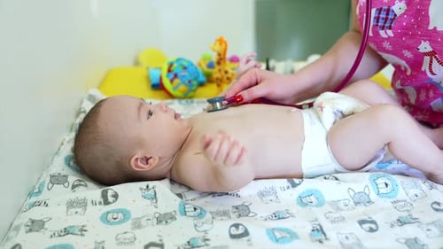 Baby Examined with Stethoscope in Medical Office