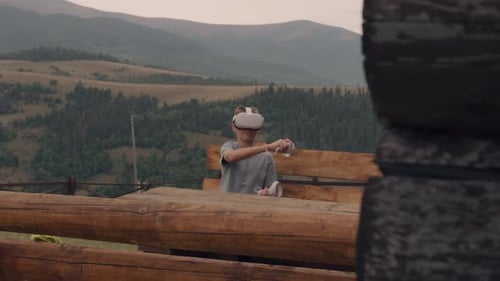 Young Guy Playing Games in VR Headset on Nature
