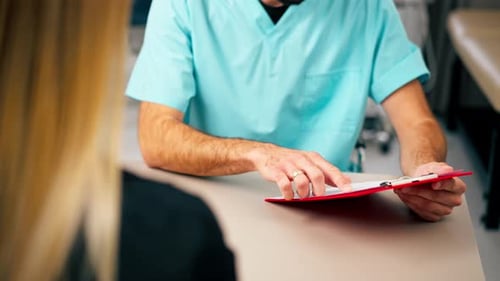 Healthcare Provider Explains Medical Paperwork to Patient