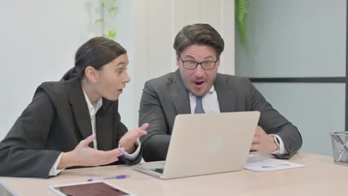Business Team Celebrating Success at Office Laptop